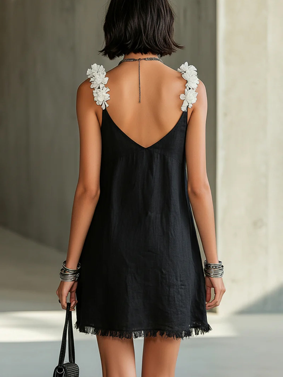 Black mini dress with V-neck and floral straps