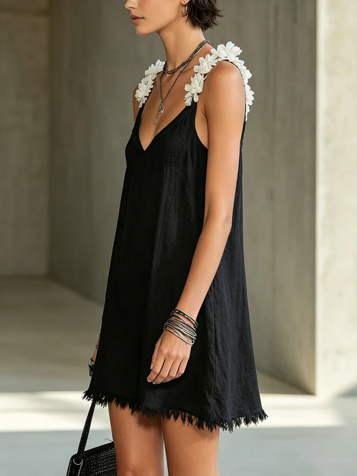 Black mini dress with V-neckline and floral straps