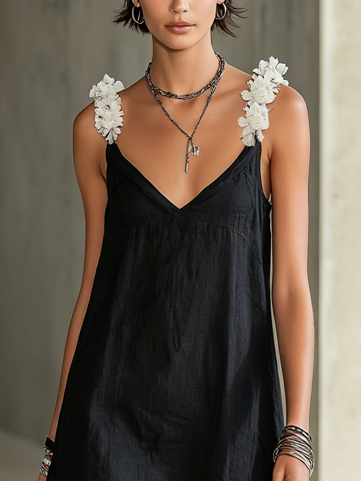 Black mini dress with V-neck and floral straps